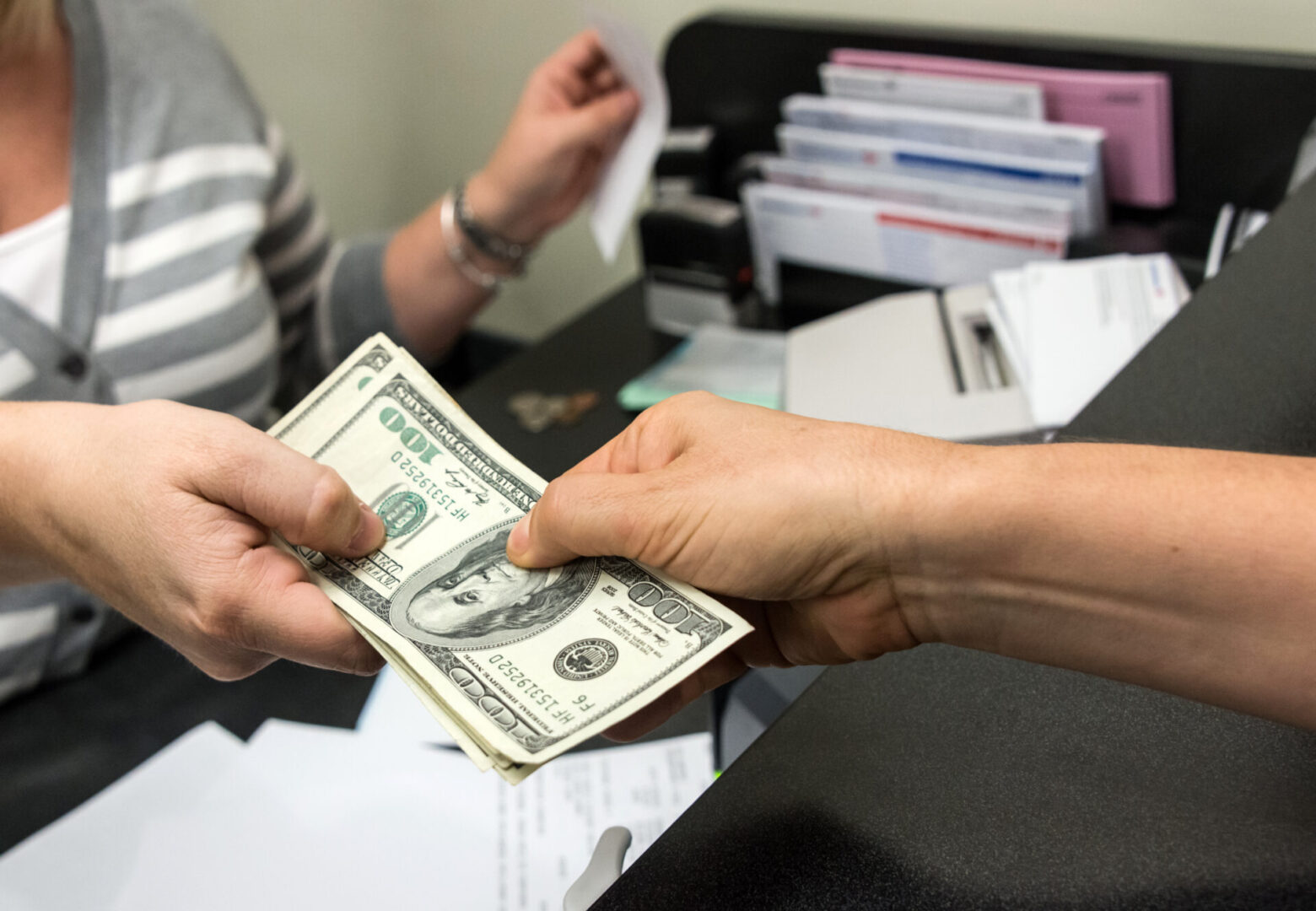 Exchanging money at a bank counter.