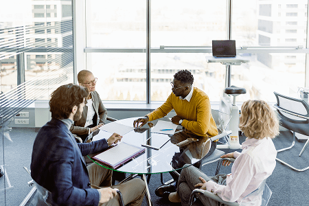 Four people having a business meeting.